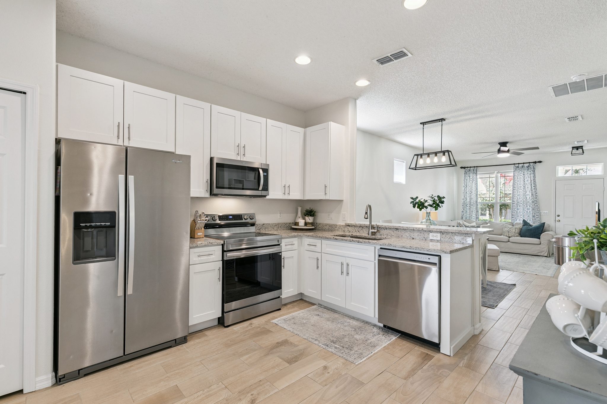 Kitchen with stainless steel appliances, granite counters, and a breakfast bar at 13449 Carroway St, Windermere