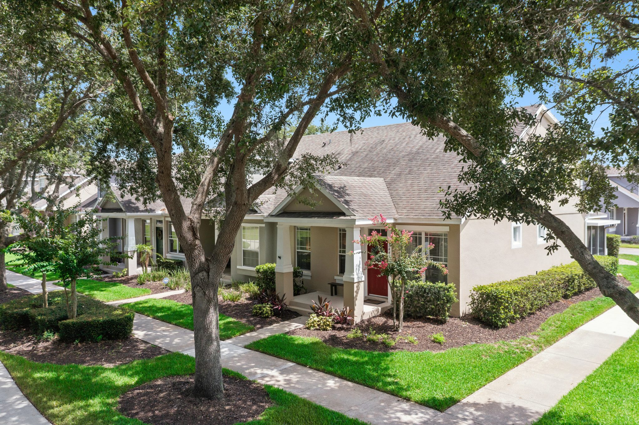 Aerial view of the home framed by a mature oak canopy at 13449 Carroway St, Windermere