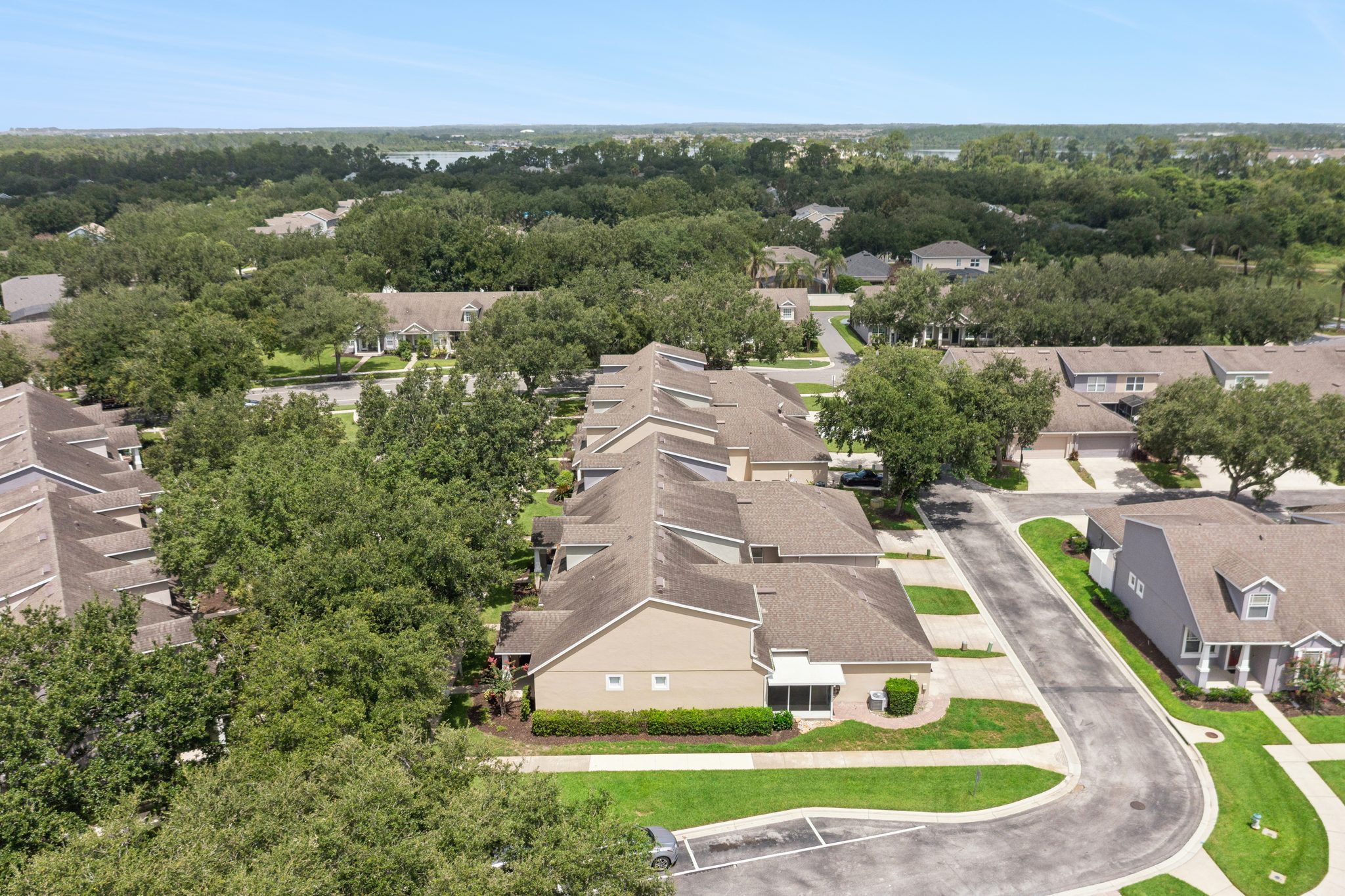 Aerial over Merrick Landing with distant conservation and water views at 13449 Carroway St, Windermere